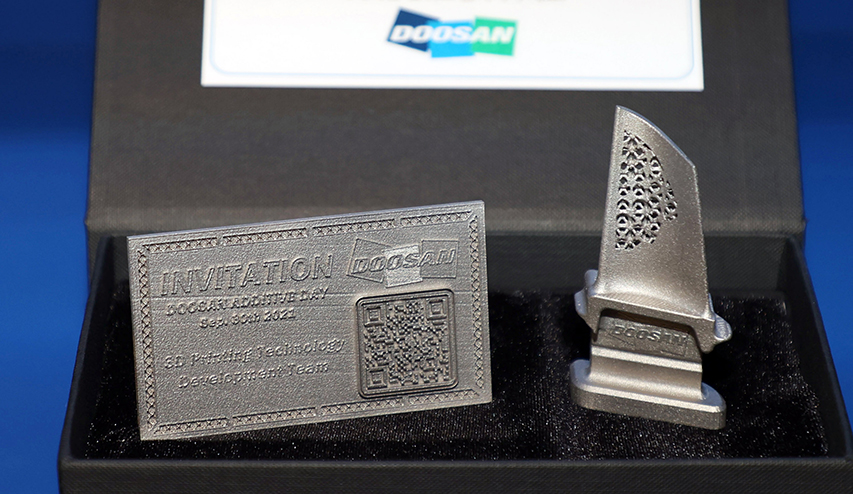 Invitation card and turbine blade model developed at Doosan Heavy’s 3D printing fabrication shop. Entry into the ceremony made possible by scanning QR code on the metal invitation card.