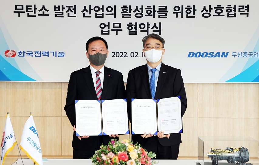 Photo 1. Sung-Arm Kim, CEO of KEPCO E&C and Hongook Park, CEO of Doosan Heavy’s Power Services BG (on the right) pose for a photo at the signing ceremony held at Doosan Heavy’s Changwon headquarters on Feb. 16.