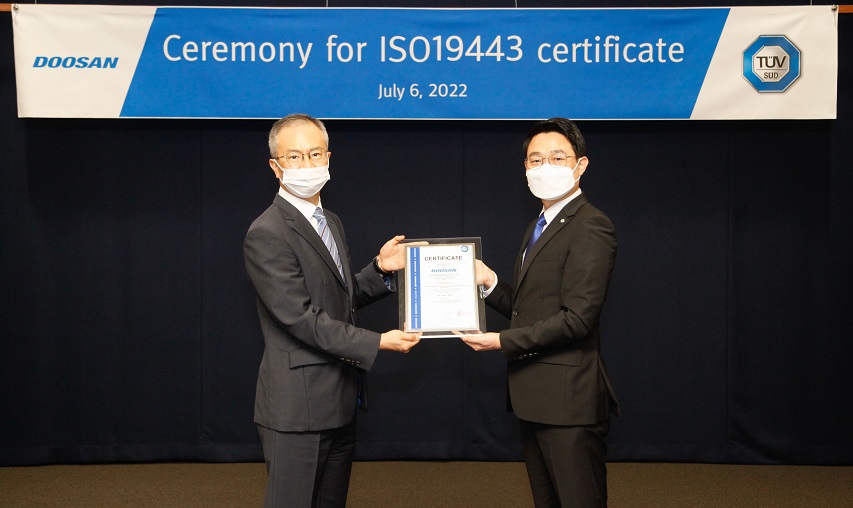 Hongkyu Kang, VP of Doosan Enerbility’s Nuclear Business Group (on the left) and Jung-Wook Seo, CEO of TUV SUD Korea, pose for a photo at the ISO 19443 certification ceremony held at Bundang Doosan Tower.  