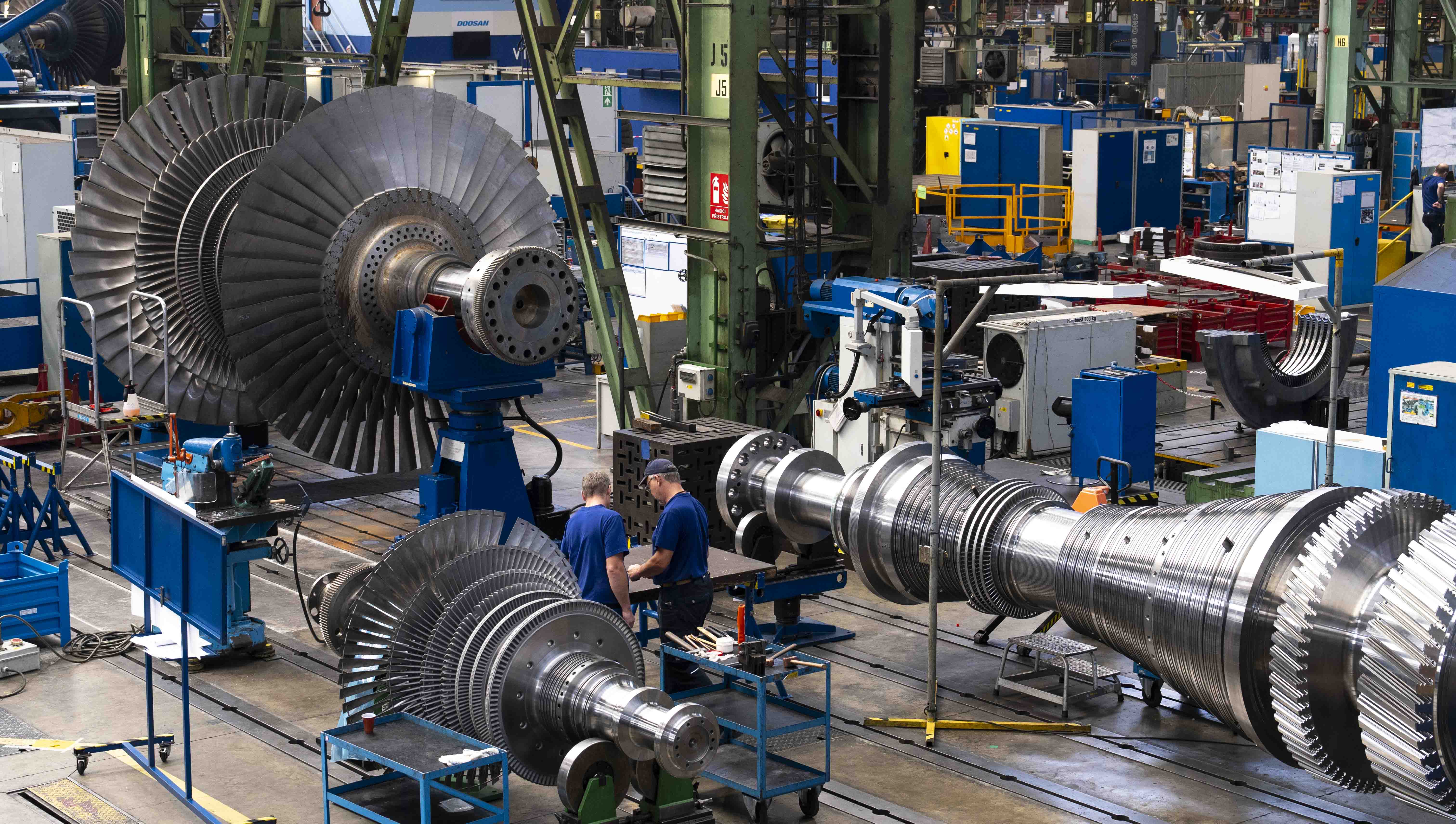Employees looking over a steam turbine at the Doosan Skoda Power manufacturing plant in Plzen.