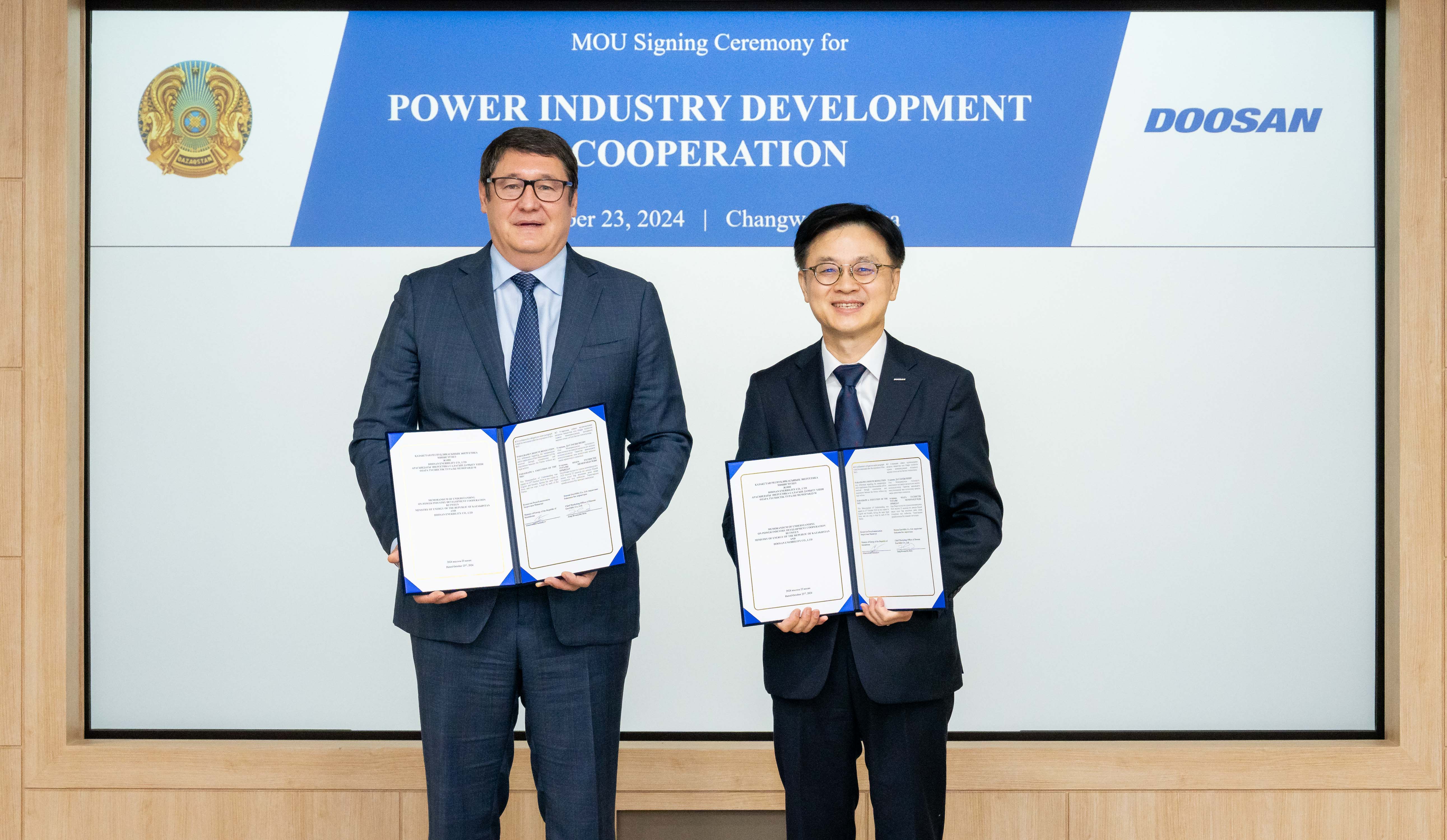 On Oct. 23, Kazakhstan’s Minister of Energy, Almas Sadam Satkaliyev (on the left), and Doosan Enerbility CMO Jungkwan Kim pose for a photo after signing the “MOU on Cooperation for Kazakhstan’s Power Industry Development” at Doosan Enerbility’s Changwon HQ.