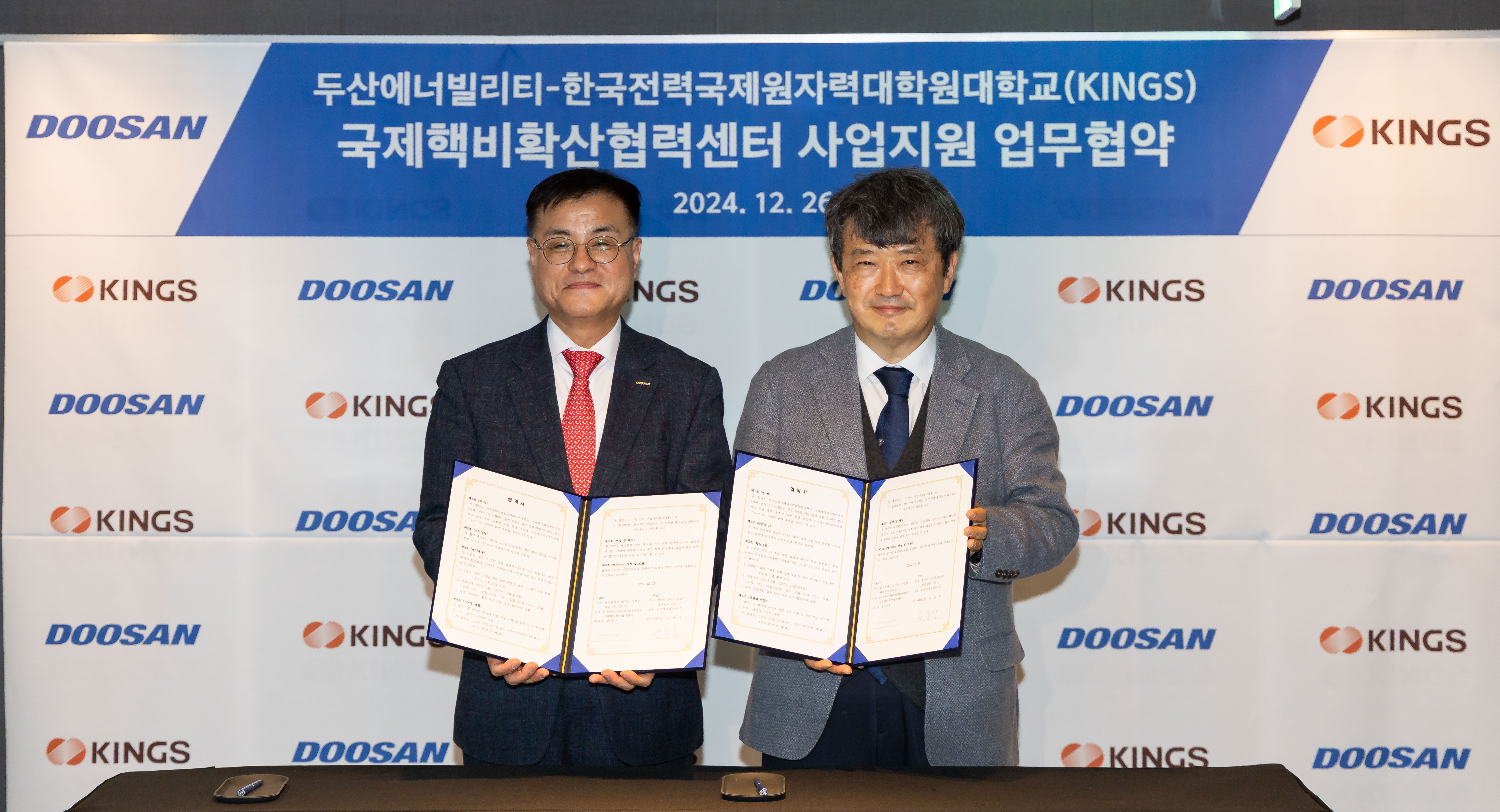 Yongsoo Hwang, Director of INC (on the right) and Jongdoo Kim, CEO of Doosan Enerbility Nuclear BG, pose for a photo after signing the MOU at the JW Marriott Seoul on Dec. 26.